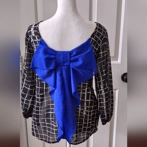 Women's sheer blouse with large bow accent on back